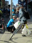 A cyclist helps repair a bike